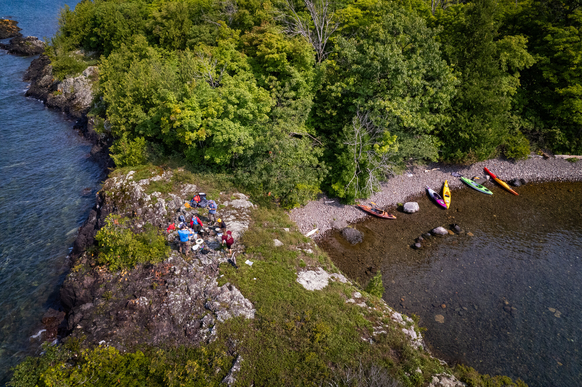 A Thrive Tours group gathered on a Northern Ontario shoreline